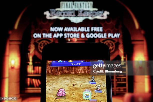The Final Fantasy Record Keeper smartphone game, co-developed by Square Enix Co. And DeNA Co., is displayed on an Apple Inc. IPhone 5 smartphone in...