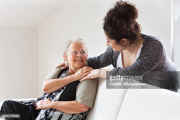 caregiver helping senior woman - chubby arab stock pictures, royalty-free photos & images