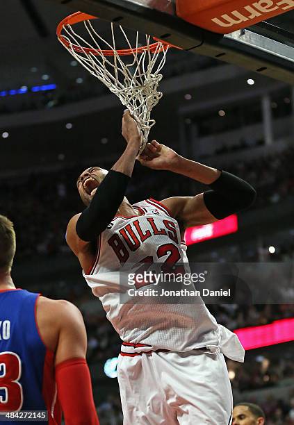 Taj Gibson of the Chicago Bulls yells after dunking against the Detroit Pistons at the United Center on April 11, 2014 in Chicago, Illinois. The...