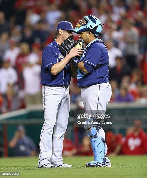 Grant Balfour of the Tampa Bay Rays talks with Jose Molina in the 9th inning of the 2-1 win over the Cincinnati Reds at Great American Ball Park on...