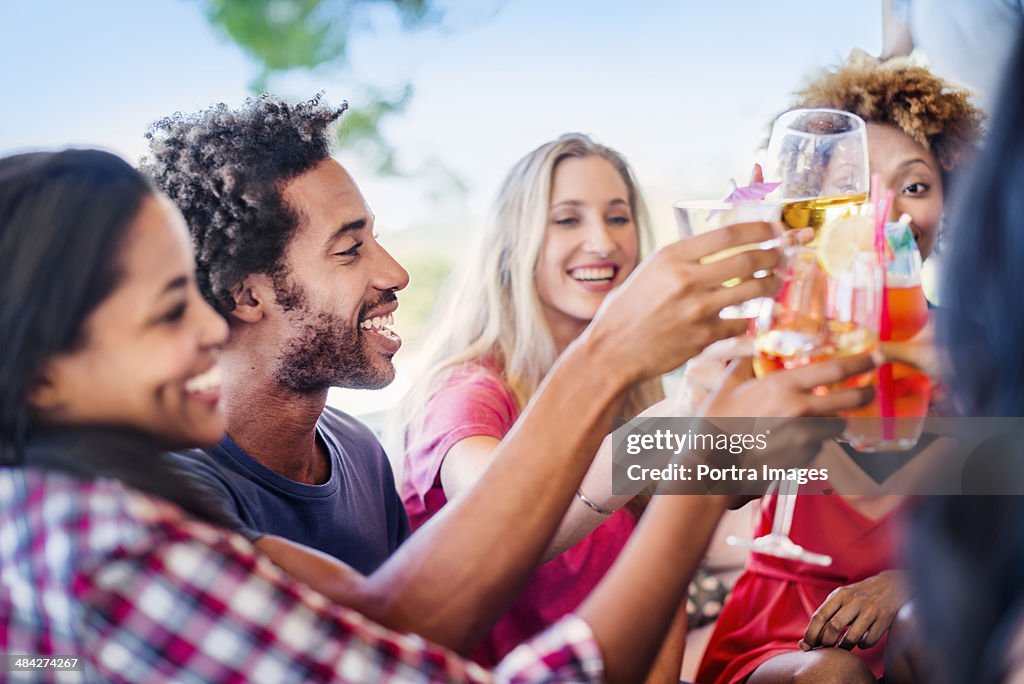 Friends toasting outside