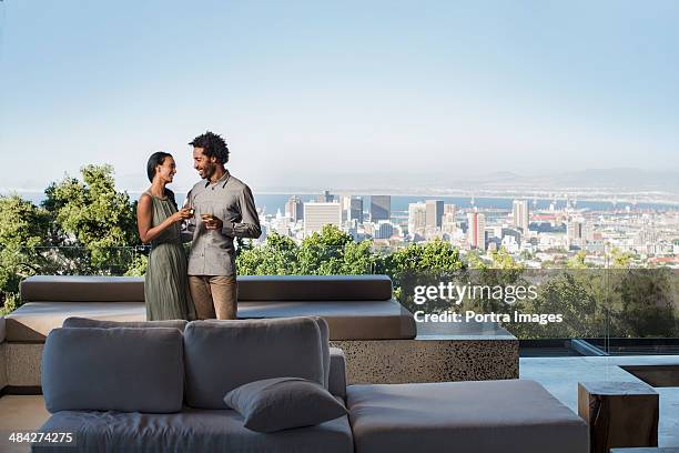 couple standing outside - balcony stock pictures, royalty-free photos & images