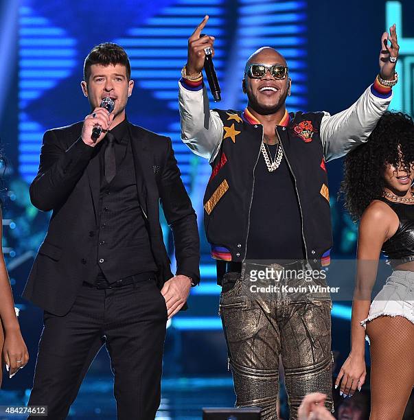 Recording artists Robin Thicke and Flo Rida perform onstage during the Teen Choice Awards 2015 at the USC Galen Center on August 16, 2015 in Los...