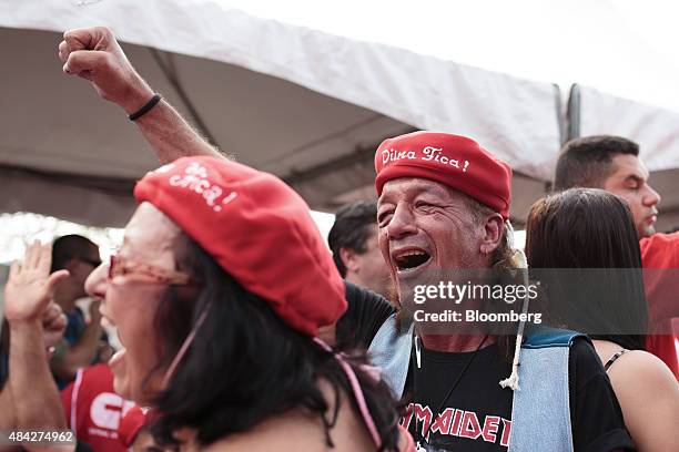 Demonstrator supporting Brazilian President Dilma Rousseff holds up his fist during a protest in Sao Paulo, Brazil, on Sunday, Aug. 16, 2015....