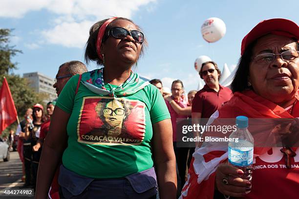 Demonstrator wears a T-shirt featuring a portrait of Brazilian President Dilma Rousseff during a protest in Sao Paulo, Brazil, on Sunday, Aug. 16,...