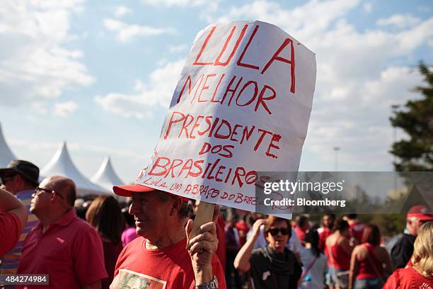 Demonstrator dressed in the colors of the Workers' Party holds a sign supporting former Brazilian President Luiz Inacio Lula da Silva during a...