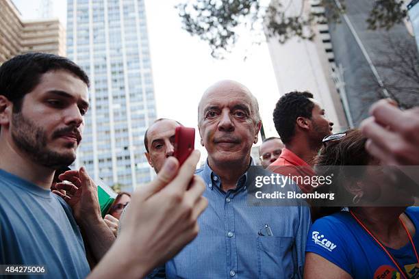 Jose Serra, former governor of Sao Paulo, center, marches with other demonstrators during a protest in Sao Paulo, Brazil, on Sunday, Aug. 16, 2015....
