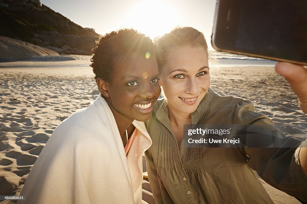 Two woman taking self portrait with smart phone