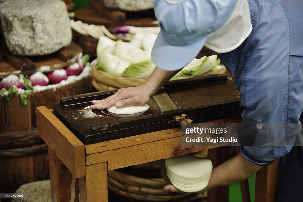 Workers cutting turnip in factory of pickles