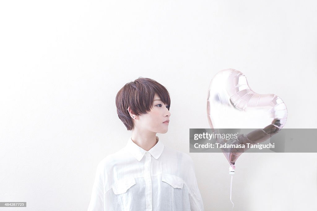 Woman having balloon of heart shape