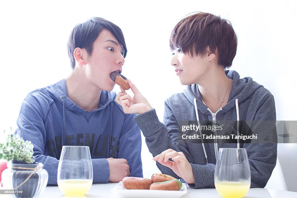 Young couple having donuts