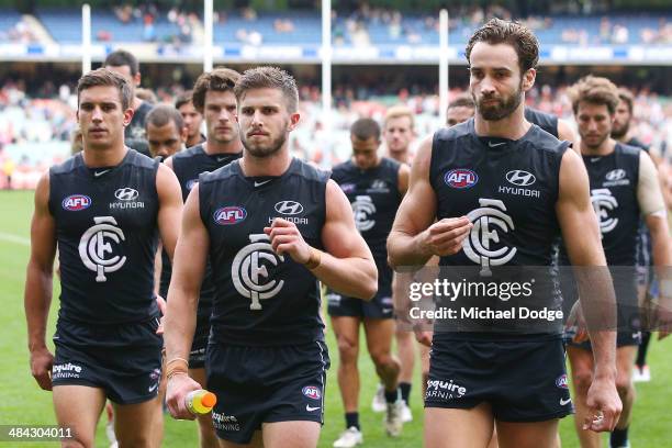 Marc Murphy and Andrew Walker of the Blues lead the team off after their defeat during the round four AFL match between the Carlton Blues and the...
