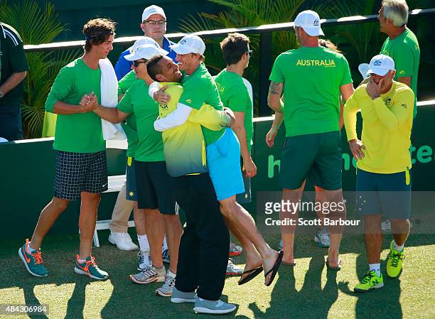 The Australian team including captain Wally Masur, John Millman, Sam Groth, Thanasi Kokkinakis and Nick Kyrgios celebrate as teammate Lleyton Hewitt...