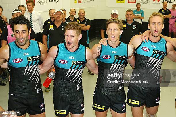 Power players celebrate after the round 4 AFL game between Port Adelaide and the Brisbane Lions at Adelaide Oval on April 12, 2014 in Adelaide,...