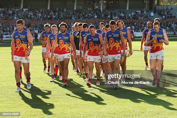 Lions players come from the field after the round 4 AFL game between Port Adelaide and the Brisbane Lions at Adelaide Oval on April 12, 2014 in...