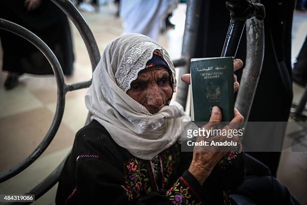 Palestinian elderly woman shows her passport as dozens of Palestinians wait for the passport check at the Palestinian side of Rafah border crossing...