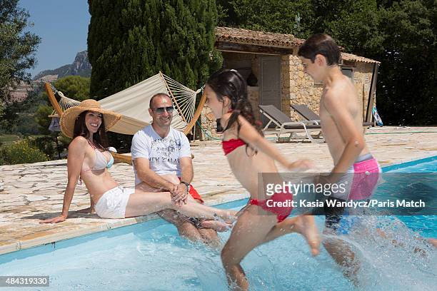 Former player and rugby coach Philippe Saint-Andre is photographed with his wife Patricia and their children Jules and Paloma at their home for Paris...