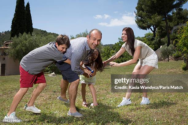 Former player and rugby coach Philippe Saint-Andre is photographed with his wife Patricia and their children Jules and Paloma at their home for Paris...