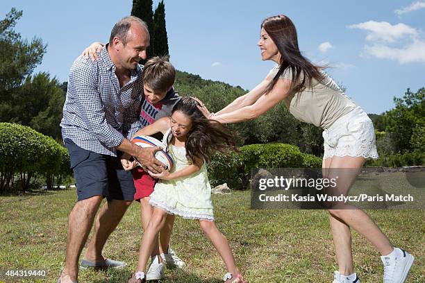 Former player and rugby coach Philippe Saint-Andre is photographed with his wife Patricia and their children Jules and Paloma at their home for Paris...