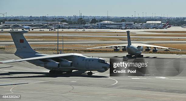 Chinese Ilyushin IL-76s aircraft taxis past a sister plane at Perth International Airport after returning from the on-going search operations for...