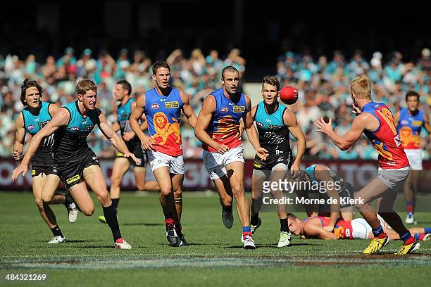 Trent West of the Lions passes the ball during the round 4 AFL game between Port Adelaide and the Brisbane Lions at Adelaide Oval on April 12, 2014...