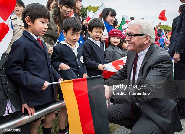 German Foreign Minister Frank-Walter Steinmeier talks to children during his visit to the monument for the 1945 atomic bomb victims at the Hiroshima...