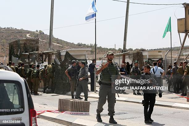 Israeli security forces stand guard near a checkpoint where Palestinian Mohammed Bassam Amsha al-Atrash was shot dead by Israeli troops after he had...