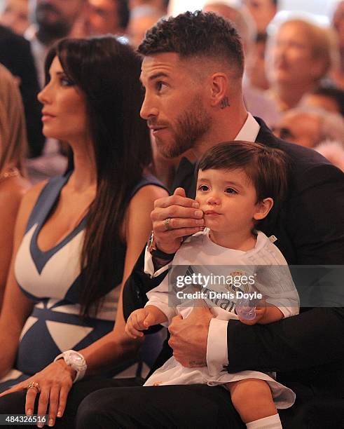 Sergio Ramos of Real Madrid holds his son Sergio Junior Ramos along with his wife Pilar Rubio during a press conference to announce his new five-year...