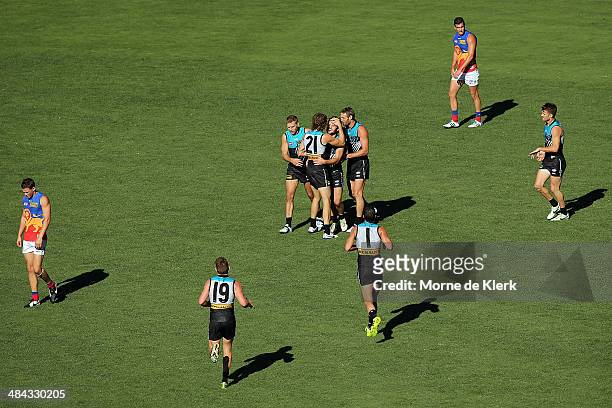 Sam Gray of the Power is congratulated by teammates after kicking a goal during the round 4 AFL game between Port Adelaide and the Brisbane Lions at...