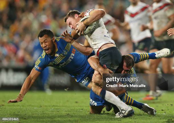 James Maloney of the Roosters is tackled by Tim Mannah and Joseph Paulo of the Eels during the round 6 NRL match between the Parramatta Eels and the...