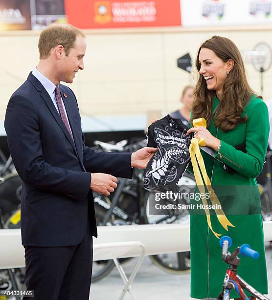 Catherine, Duchess of Cambridge and Prince William, Duke of Cambridge are given a mini cycling shirt for Prince George as a gift as they visit the...