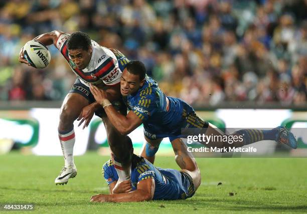 Michael Jennings of the Roosters is tackled by Will Hopoate of the Eels during the round 6 NRL match between the Parramatta Eels and the Sydney...