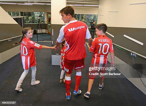 Harry Kewell of the Heart walks down the players tunnel with his children after playing his final match and retiring from football during the round...