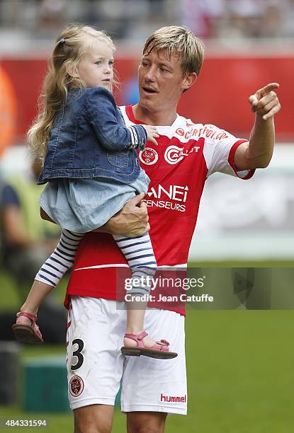 Franck Signorino of Stade de Reims holds his daughter after the French Ligue 1 match between Stade de Reims and Olympique de Marseille at Stade...