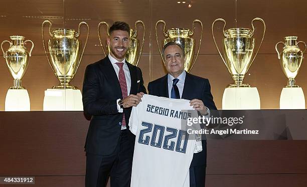 Sergio Ramos of Real Madrid poses with Real president Florentino Perez after signs his new five-year contract at the Santiago Bernabeu stadium on...