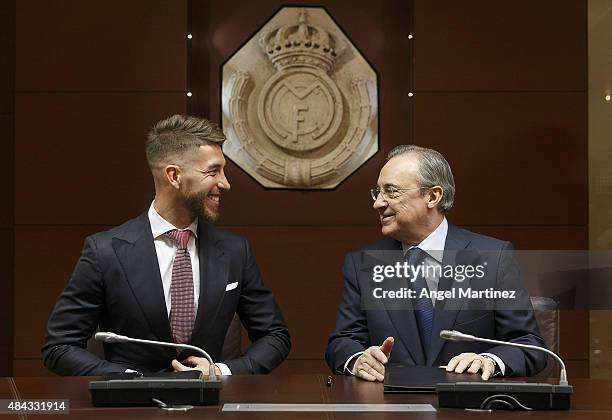 Sergio Ramos of Real Madrid smiles at Real president Florentino Perez before to announce Ramos' new five-year contract with Real Madrid at the...
