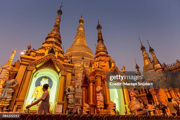pilgrims and visitors of shwedagon after sunset - shwedagon pagoda stock pictures, royalty-free photos & images