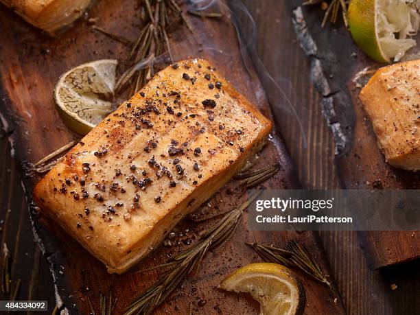 cedar plank salmon fillets hot off the bbq - cedar plank stock pictures, royalty-free photos & images