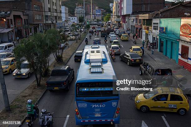 Bus from the Masivo Integrado de Occidente public transportation system travels down a street in Cali, Colombia, on Wednesday, Aug. 12, 2015....