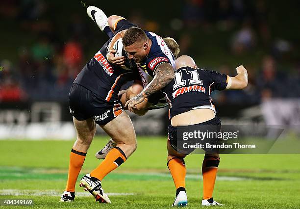 Tariq Sims of the Cowboys is tackled by the Tigers defence during the round 6 NRL match between the Wests Tigers and the North Queensland Cowboys at...