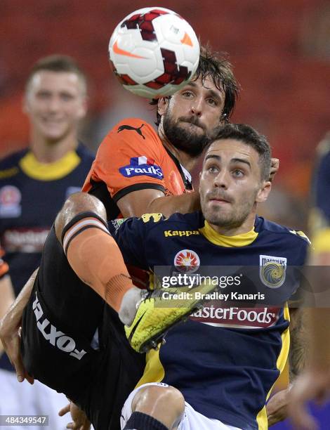 Thomas Broich of the Roar and Anthony Caceres of the Mariners challenge for the ball during the round 27 A-League match between Brisbane Roar and the...