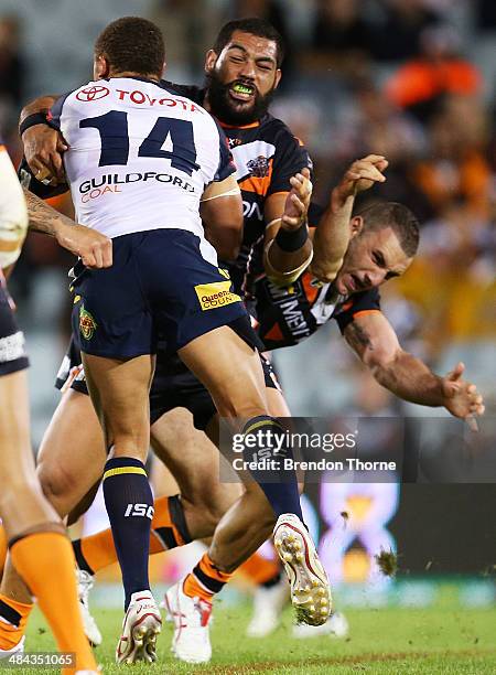 Robbie Farah of the Tigers dislocates his elbow in an attempted tackle on Ray Thompson of the Cowboys during the round 6 NRL match between the Wests...