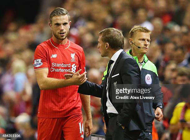 Jordan Henderson of Liverpool shakes hands with Brendan Rodgers manager of Liverpool as he is substituted during the Barclays Premier League match...