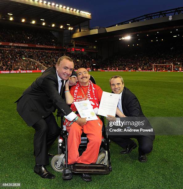 Ian Ayre chief executive of Liverpool FC gives award to John Smith alongside Tom Kiddell Private Secratary to the Prime Minister at half time of the...