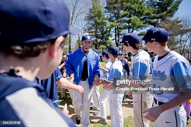 Zachary Gardiner of Westbrook, gets high fives on opening day for Westbrook Little League where Gardiner and other members of the 2005 New England...