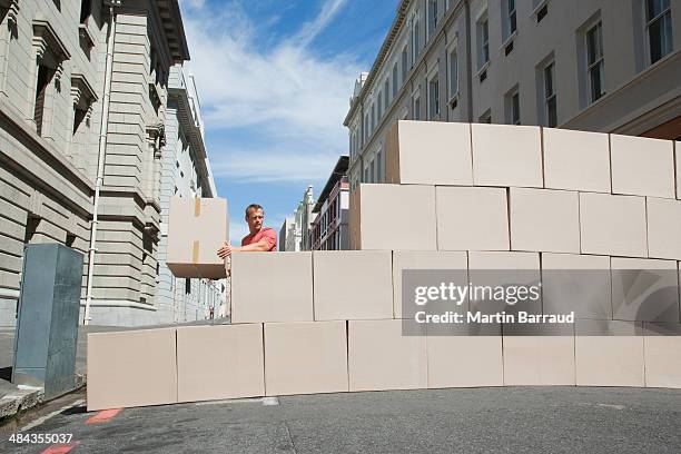 man carrying box in roadway - preciseness stock pictures, royalty-free photos & images