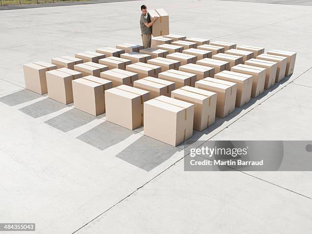 man organizing boxes outdoors - cardboard box top view stock pictures, royalty-free photos & images