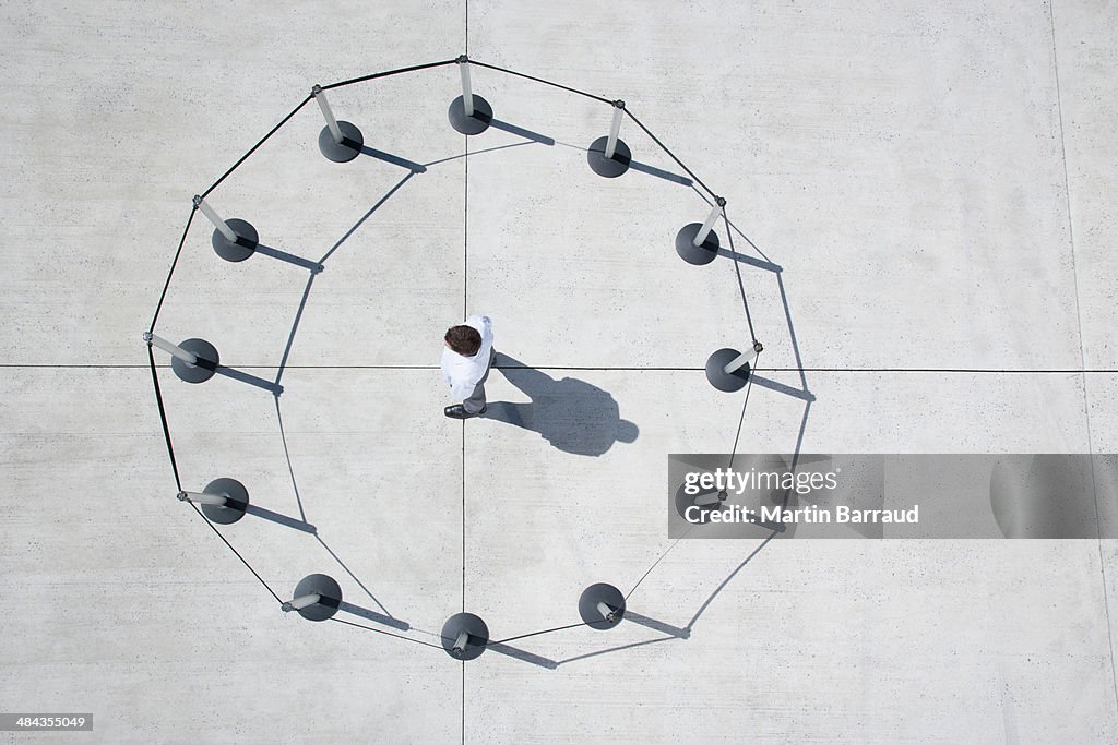 Man inside circle of cordon posts