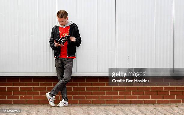 Fan reads a match day programme prior to the Barclays Premier League match between Southampton and Cardiff City at St Mary's Stadium on April 12,...