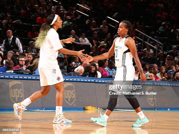 Epiphanny Prince of the New York Liberty hi fives Candice Wiggins of the New York Liberty during a game against the Tulsa Shock on August 15, 2015 at...